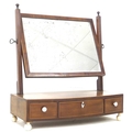 A George III mahogany toilet mirror, of rectangular form, with circular bone feet, 52 by 22.5 by 56c... 