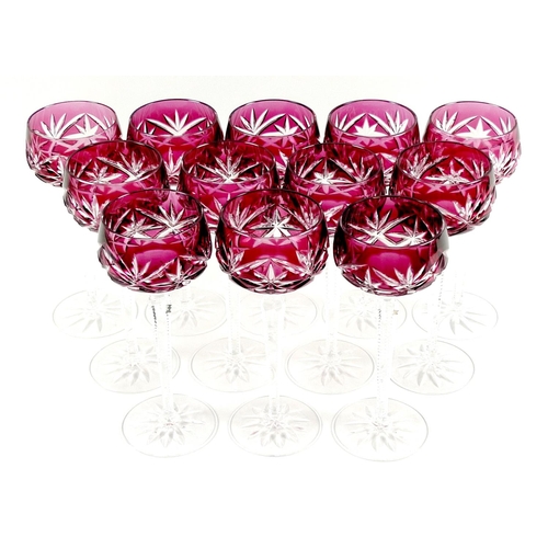 20 - A set of twelve Bohemian glass hock glasses, with cranberry flashed glass bowls, raised on hexagonal... 