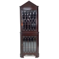 A Victorian Gothic style mahogany corner display cabinet, pointed arch pediment over two bevelled an... 
