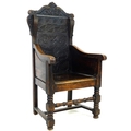 An oak Wainscot type armchair, 19th century with some 17th century parts, the solid back carved with... 