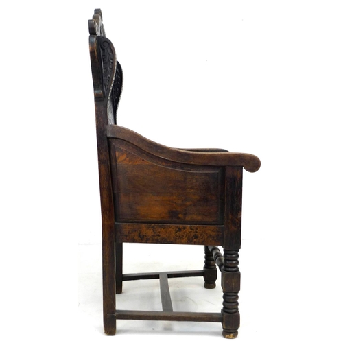 229 - An oak Wainscot type armchair, 19th century with some 17th century parts, the solid back carved with... 