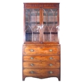 A George III mahogany secretaire bookcase, with astragal glazed doors above four drawers, the top fi... 