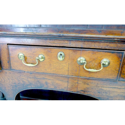 242 - A large George III oak Welsh dresser, cornice over a closed three shelf waterfall plate rack, the ba... 