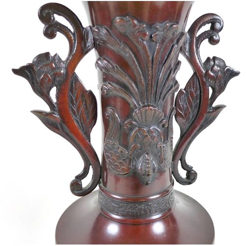 5 - A modern Chinese bronzed vase, of baluster form with long flared neck having pierced and scrolled ha... 