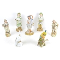 A group of seven continental porcelain and bisque figurines, comprising two porcelain cockatoos, an ... 
