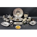 A large collection of silver plated wares including a strawberry plate, an ice bucket and tongs, tea... 