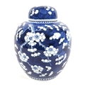 A Chinese blue and white ginger jar and cover the cobalt blue ground decorated with cherry blossoms ... 
