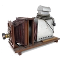 A Victorian slide projector, with mahogany frame, leather bellows to brass lens, 'Thornton Pickard B... 