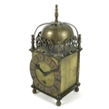 A brass cased lantern clock, in the 17th century style, with strapwork bell top within pierced spand... 