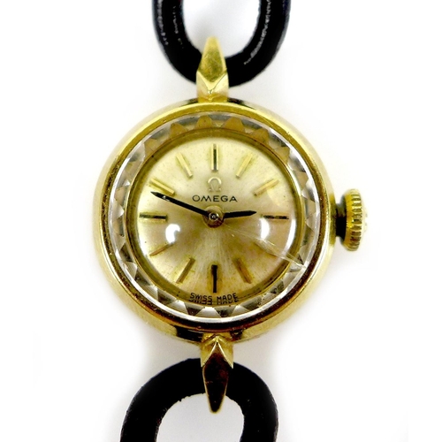 131 - An Omega 18K gold cased lady's wristwatch, circa 1965, the circular gold dial with gold and black in... 