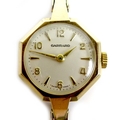 A Garrard 9ct gold lady's wristwatch, circa 1969, with octagonal case, circular silvered dial with r... 