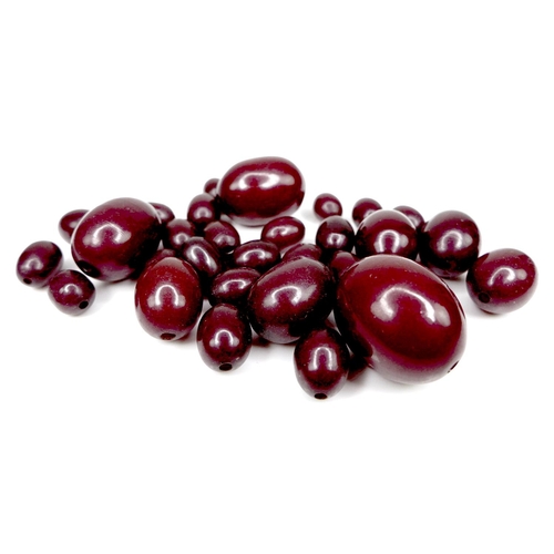 170 - A group of loose cherry amber bakelite beads, largest 22.9mm by 18.6mm, smallest 10mm by 7.6mm, 34.3... 