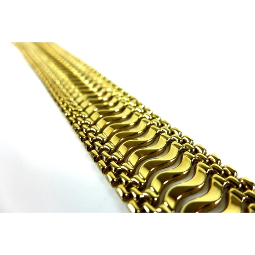 315 - A 9ct gold wide wavy link bracelet, 2.2 by 18cm long, 22.9g.