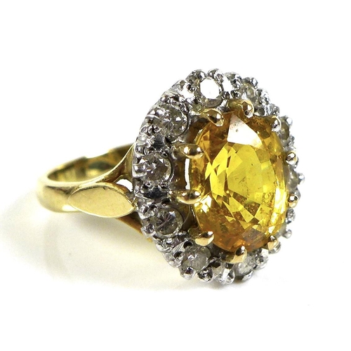 319 - An 18ct gold, diamond and cairngorm citrine dress ring, the central yellow stone, 10 by 8.7mm, surro... 