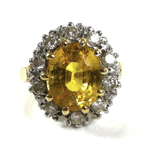 319 - An 18ct gold, diamond and cairngorm citrine dress ring, the central yellow stone, 10 by 8.7mm, surro... 