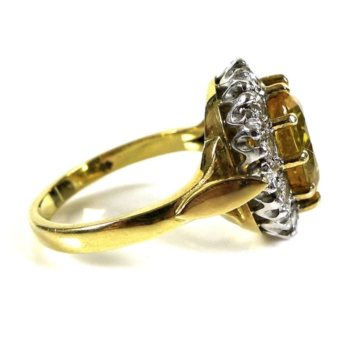 319 - An 18ct gold, diamond and cairngorm citrine dress ring, the central yellow stone, 10 by 8.7mm, surro... 