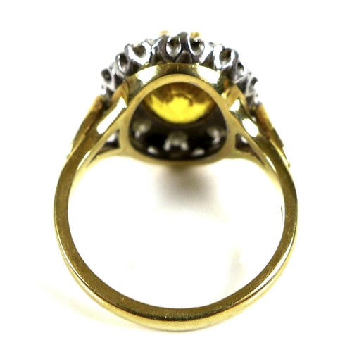 319 - An 18ct gold, diamond and cairngorm citrine dress ring, the central yellow stone, 10 by 8.7mm, surro... 