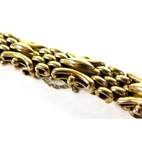 324 - A 15ct gold fancy link bracelet, with safety chain, together with a spare link, 27.1g total.