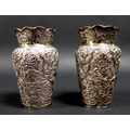 A pair of Chinese white metal vases, of balluster form, with scallop edged rims, the body chased wit... 