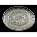 A George III Irish silver waiter tray, of oval form with engraved decoration of flowers surrounded b... 