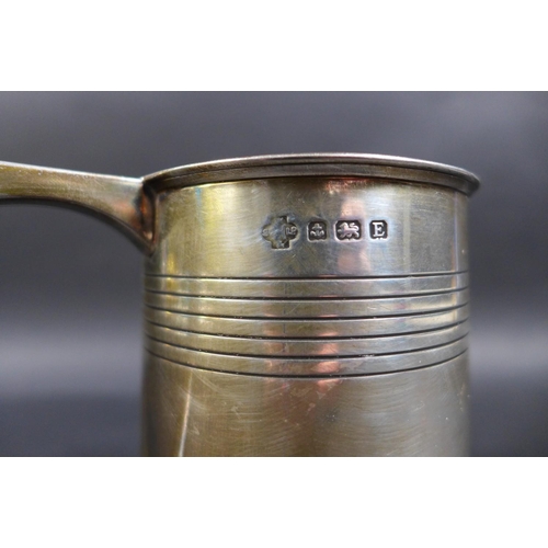 62 - A George V silver 1 pint tankard, with stepped rim and base, scroll handle and two bands of reeded d... 