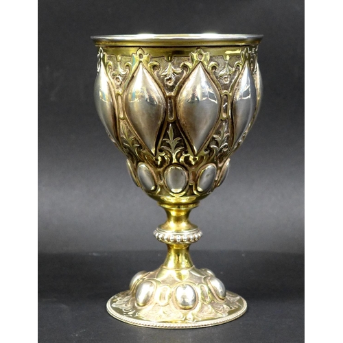 67 - A Victorian silver gilt chalice in the Gothic style of Pugin, the bowl and foot chased with scrollin... 