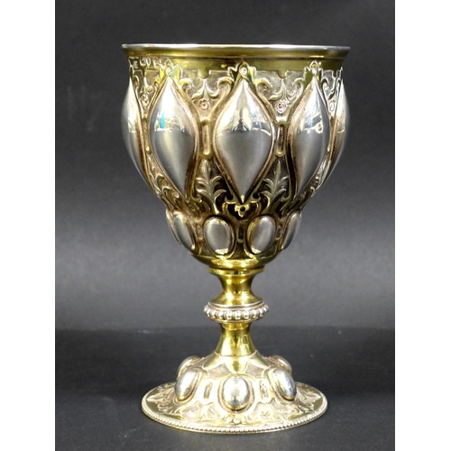 67 - A Victorian silver gilt chalice in the Gothic style of Pugin, the bowl and foot chased with scrollin... 