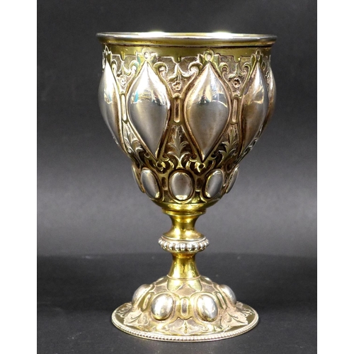 67 - A Victorian silver gilt chalice in the Gothic style of Pugin, the bowl and foot chased with scrollin... 