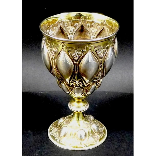 67 - A Victorian silver gilt chalice in the Gothic style of Pugin, the bowl and foot chased with scrollin... 