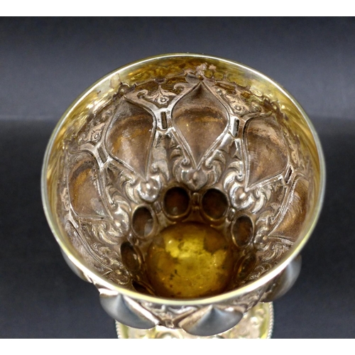 67 - A Victorian silver gilt chalice in the Gothic style of Pugin, the bowl and foot chased with scrollin... 