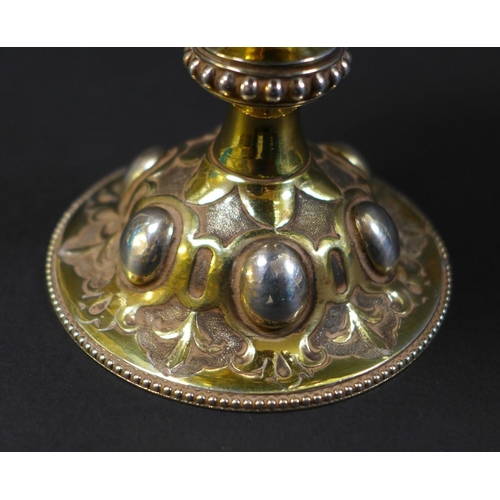 67 - A Victorian silver gilt chalice in the Gothic style of Pugin, the bowl and foot chased with scrollin... 