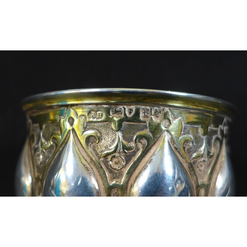 67 - A Victorian silver gilt chalice in the Gothic style of Pugin, the bowl and foot chased with scrollin... 