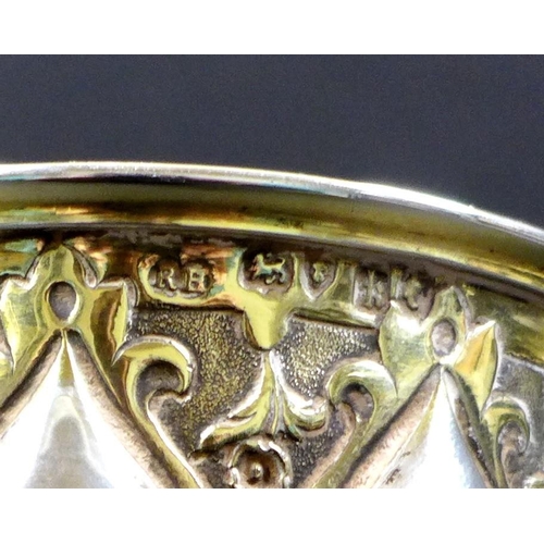 67 - A Victorian silver gilt chalice in the Gothic style of Pugin, the bowl and foot chased with scrollin... 