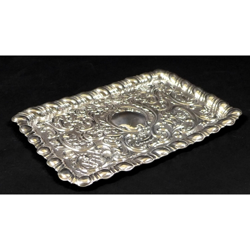 68 - An Edward VII silver dressing table tray, of rectangular form with embossed Rococo style decoration,... 