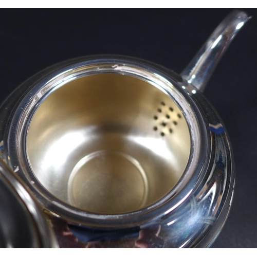 70 - An Art Deco silver bachelor's teapot, of squat stepped ovoid form, with ebony handle and finial, rai... 