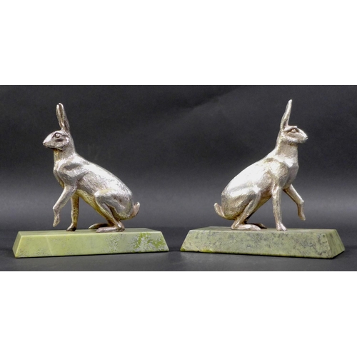 74 - A pair of contemporary silver sculptures, each modelled realistically as a hare, in seated pose with... 