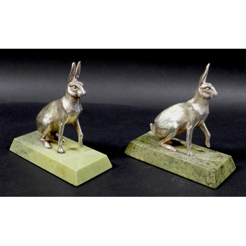 74 - A pair of contemporary silver sculptures, each modelled realistically as a hare, in seated pose with... 