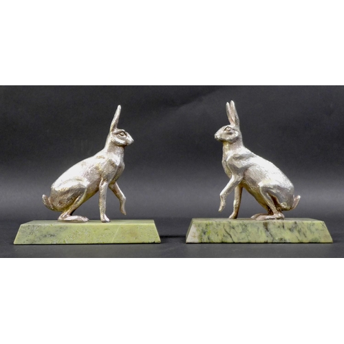 74 - A pair of contemporary silver sculptures, each modelled realistically as a hare, in seated pose with... 