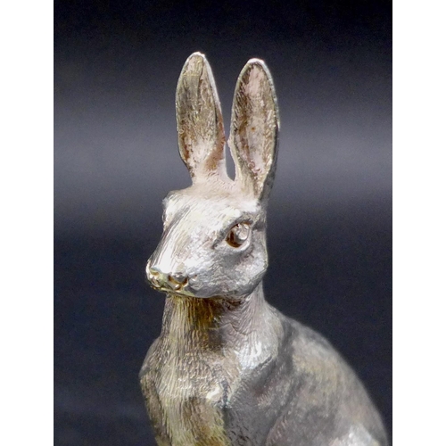 74 - A pair of contemporary silver sculptures, each modelled realistically as a hare, in seated pose with... 