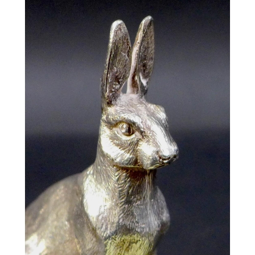 74 - A pair of contemporary silver sculptures, each modelled realistically as a hare, in seated pose with... 