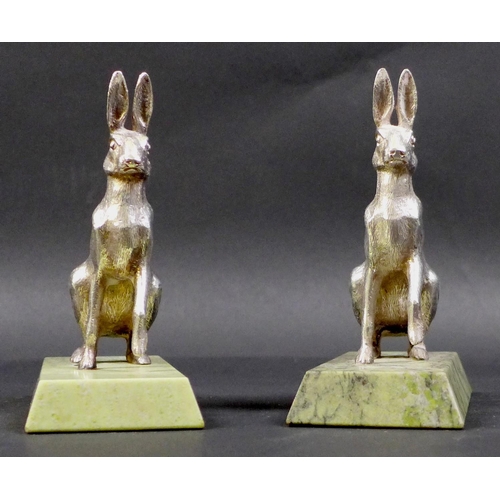 74 - A pair of contemporary silver sculptures, each modelled realistically as a hare, in seated pose with... 