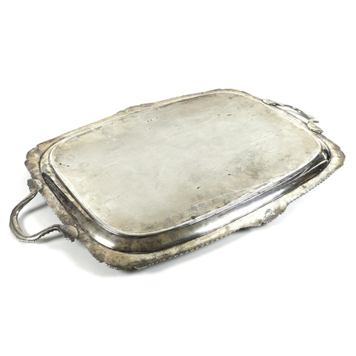 78 - A large Edward VII silver twin handled serving tray, with gadrooned and shell clasped rim, the centr... 