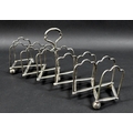 An Edwardian Elkington and Co telescopic toast rack, concertina folding action, with six shaped sect... 