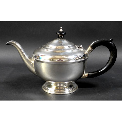 70 - An Art Deco silver bachelor's teapot, of squat stepped ovoid form, with ebony handle and finial, rai... 