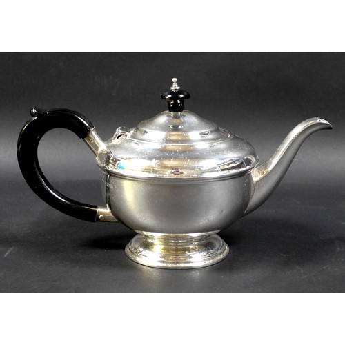 70 - An Art Deco silver bachelor's teapot, of squat stepped ovoid form, with ebony handle and finial, rai... 