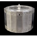 A George III silver tea caddy, of fourteen sided navette form, the oval flush hinged cover with knop... 