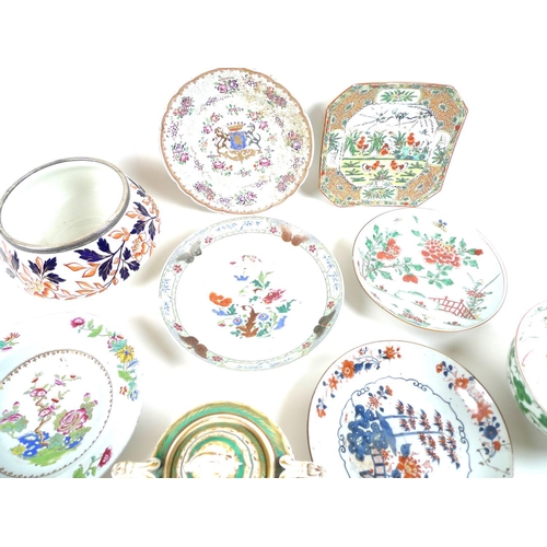 15 - A group of European and Asian ceramics, including an early 19th century French porcelain armorial ca... 