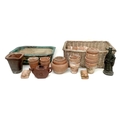 A collection of thirty one terracotta plant pots, and two tortoise plant stand feet, together with a... 