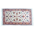 A small Persian rug, cream floral decoration, signed to one end, 80 by 150cm.