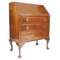 A reproduction mahogany bureau, with fall front, to fitted interior, above three drawers, raised on ... 